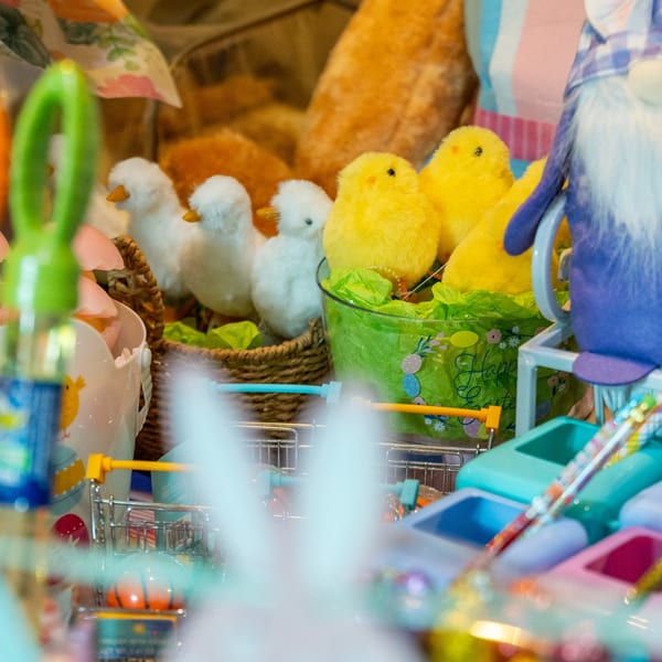 Easter decorations featuring yellow and white chicks, a blue gnome, and miniature shopping carts.